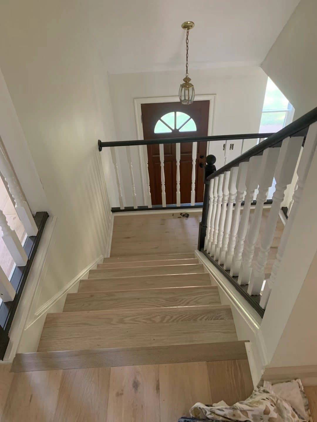 Refinished treads with turned white balusters